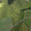 Oblique aerial view centred on the cropmarks of the ring-ditches and roundhouses, taken from the WSW.