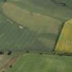 Oblique aerial view centred on the cropmarks of the unenclosed settlement, pits, rig, possible enclosure, the linear cropmarks and frost wedges, taken from the NW.
