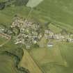 General oblique aerial view of the village, centred on the church and the burial ground, taken from the E.