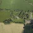 Oblique aerial view centred on the country house with the farmhouse, farmsteading and cottage adjacent, taken from the ESE.