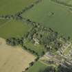 Oblique aerial view centred on the country house with the farmhouse, farmsteading and cottage adjacent, taken from the E.