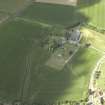 General oblique aerial view centred on the remains of the abbey and burial-ground and the farmsteading, taken from the NE.