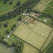 Oblique aerial view centred on the walled gardens and the house, taken from the SW.
