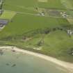 Oblique aerial view centred on the remains of the anti-tank blocks with the whisky distillery and remains of the windmill adjacent, taken from the N.