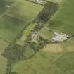 Oblique aerial view centred on the country house, walled garden, lodge, farmhouse and farmsteading, taken from the SE.