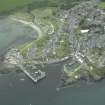 Oblique aerial view of the village centred on the harbours, taken from the NW.