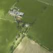Oblique aerial view centred on the farmhouse and farmsteading, taken from the ESE.