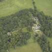 Oblique aerial view centred on the country house, walled garden, farmsteading and coach house, taken from the S.