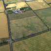 Oblique aerial view centred on the cropmarks of the pit-alignments with the farmhouse and farmsteading adjacent, taken from the WSW.