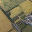 Oblique aerial view centred on the cropmarks of the pit-alignments and the farmhouse and farmsteading, taken from the WNW.