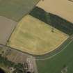 Oblique aerial view centred on the cropmarks of the pit-alignment and the possible enclosure with the remains of the church and burial ground adjacent, taken from the SE.