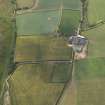 Oblique aerial view centred on the cropmarks of the fort and the farmhouse and farmsteading, taken from the NE.