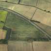 Oblique aerial view centred on the cropmarks of the Roman temporary camps and possible fort annexe, taken from the SSE.