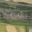 Oblique aerial view centred on the W end of the village, taken from the NNW.