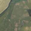 Oblique aerial view centred on the parchmarks of the Roman fort, taken from the SW.