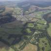 General oblique aerial view centred on the town with the country house in the foreground, taken from the SSW.