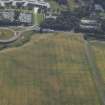 Oblique aerial view centred on the cropmarks of the settlement and fort, taken from the NNW.