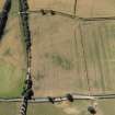 Oblique aerial view centred on the cropmarks of the Roman fort, Roman temporary camps and fort annexes, taken from the NNW.