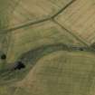 Oblique aerial view centred on the cropmarks of the rectilinear enclosure, taken from the ENE.