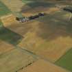 General oblique aerial view centred on the cropmarks of the rig and pits the farmhouse and farmsteading adjacent, taken from the N.