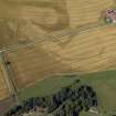 Oblique aerial view centred on the cropmarks of the possible buildings, mortuary enclosures, rig and ring-ditch with the farmhouse and farmsteading adjacent, taken from the SE.