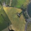 Oblique aerial view centred on the cropmarks of the brickworks, tile works and enclosure with the church adjacent, taken from the ESE.