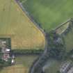 Oblique aerial view centred on the cropmarks of the enclosure, taken from the ENE.