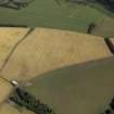 Oblique aerial view centred on the cropmarks of the enclosure and settlement, taken from the W.