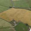 Oblique aerial view centred on the cropmarks of the enclosure, possible settlement and rig, taken from the E.