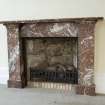 Interior. Office/Administrative block. Ground floor. Detail of simple marble fireplace.