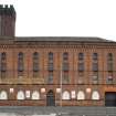 S Building. View from ESE of paint works at 108-118 Tradeston Street, note parapet, machiolation and lancets with Ghibelline crenellation of corner tower.