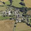 Oblique aerial view of the village centred on the church, taken from the SW.