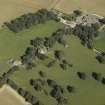 Oblique aerial view centred on the tower-house, dovecot, gardens and stable block, taken from the SW.