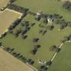 Oblique aerial view centred on the tower-house, dovecot, gardens and stable block, taken from the SE.