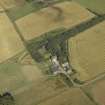 Oblique aerial view centred on the farmhouse, farmsteading and tower-house, taken from the SSW.