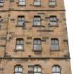 S side, Tradeston Street elevation detail showing the general arrangement of windows including first floor shouldered arch window, 2nd and 3rd floor flat ogee and 4th floor basket arch windows and two prominent string courses.