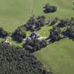 Oblique aerial view centred on the country house, hotel and hall-house with the cottage adjacent, taken from the NNW.