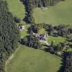 Oblique aerial view centred on the country house, hotel and hall-house with the cottage adjacent, taken from the WNW.