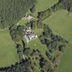 Oblique aerial view centred on the country house, hotel and hall-house with the cottage adjacent, taken from the SW.
