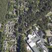 Oblique aerial view centred on the church and the school, taken from the W.