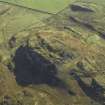 Oblique aerial view centred on the remains of the fort, taken from the NW.