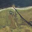 Oblique aerial view centred on the remains of the cottage, rig and sheepfold, taken from the NW.