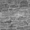 Detail of edge of carved slab set into church wall