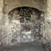 Interior. 2nd floor, NW room, detail of remains of fireplace