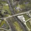 Oblique aerial view centred on the road bridge and watermill, taken from the NW.