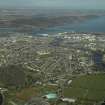 General oblique aerial view of the town centred on Inverness High School with Kessock Bridge in the distance and the park and the cemetery in the foreground, taken from the SW.