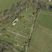 Oblique aerial view centred on the chapel, burial-ground and monument, taken from the SW.