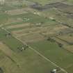 General oblique aerial view of the village centred on the pattern of dispersed buildings and layout of regular fields, taken from the W.