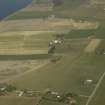 General oblique aerial view of the village centred on the pattern of dispersed buildings and layout of regular fields, taken from the SW.