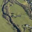 Oblique aerial view centred on the church, burial-ground, stables, farmsteading and manse, taken from the S.